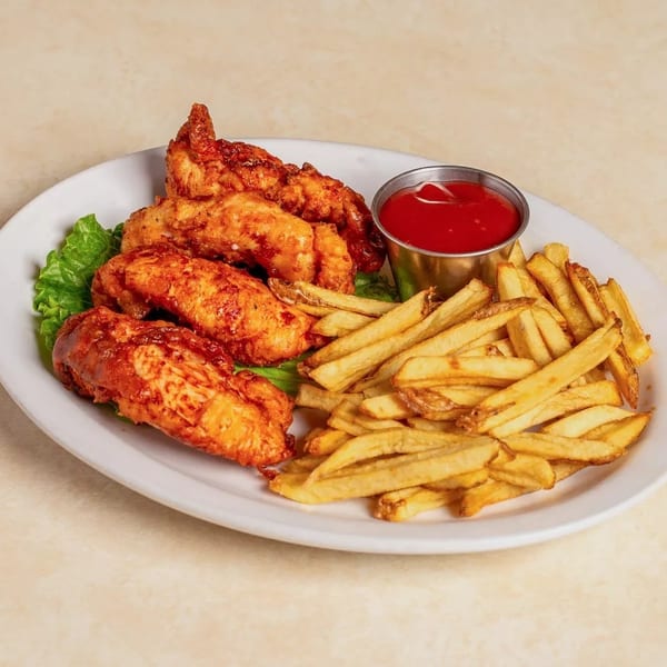 Crispy chicken tenders with a side of golden french fries and a cup of ketchup.
